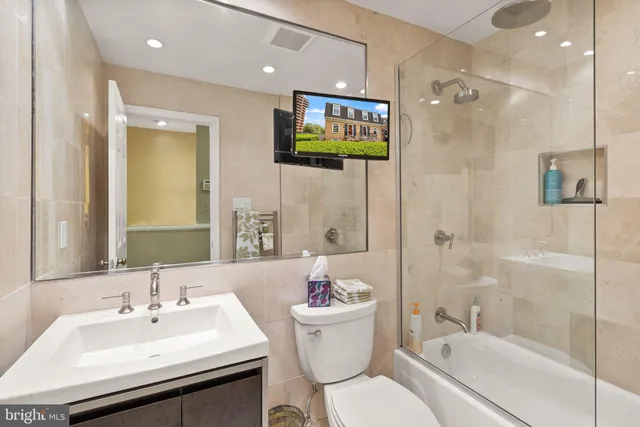 a bathroom with a sink toilet a shower and a mirror