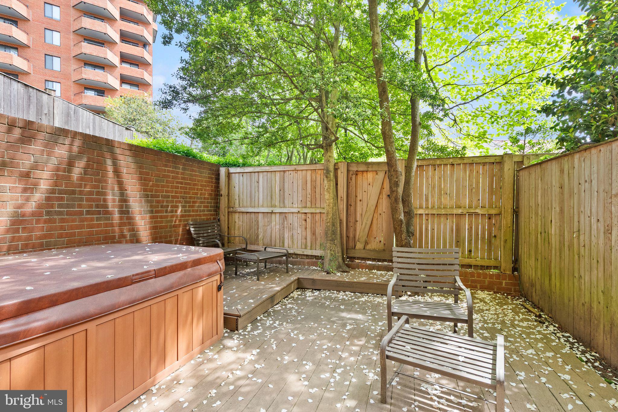 3267 Sutton Place Northwest, Unit C Washington, DC 20016 - Photo 17 of 21 a view of a backyard with wooden fence and trees