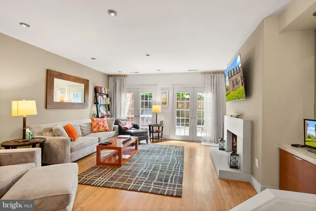 a living room with fireplace furniture and a flat screen tv