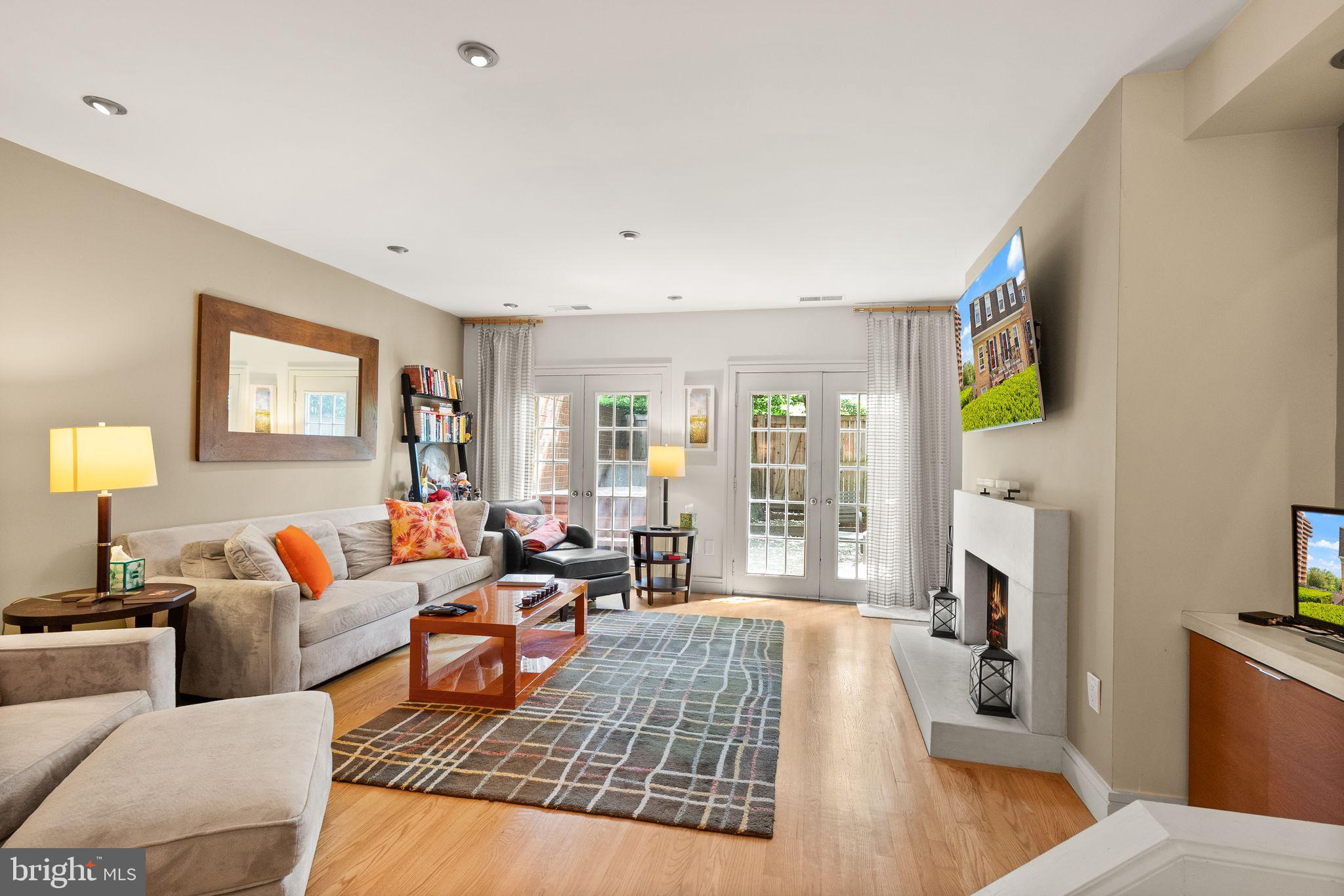 3267 Sutton Place Northwest, Unit C Washington, DC 20016 - Photo 5 of 21 a living room with fireplace furniture and a flat screen tv
