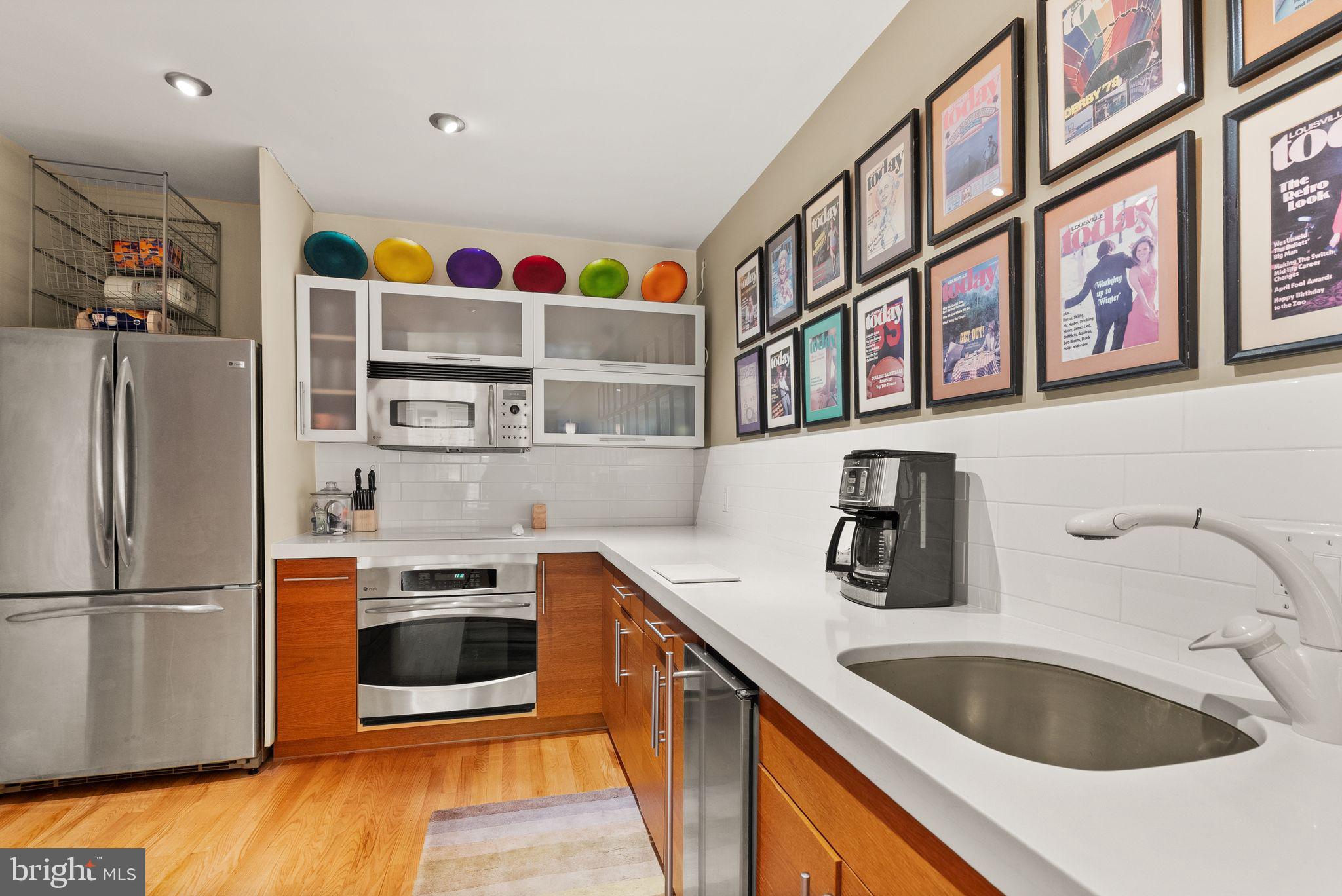 3267 Sutton Place Northwest, Unit C Washington, DC 20016 - Photo 7 of 21 a kitchen with stainless steel appliances granite countertop a refrigerator and a sink