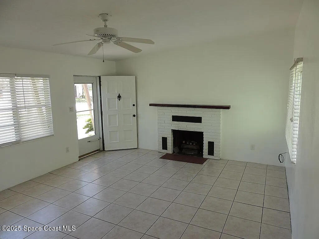 206 4th Avenue Indialantic, FL 32903 - Photo 18 of 43 an empty room with windows and fireplace