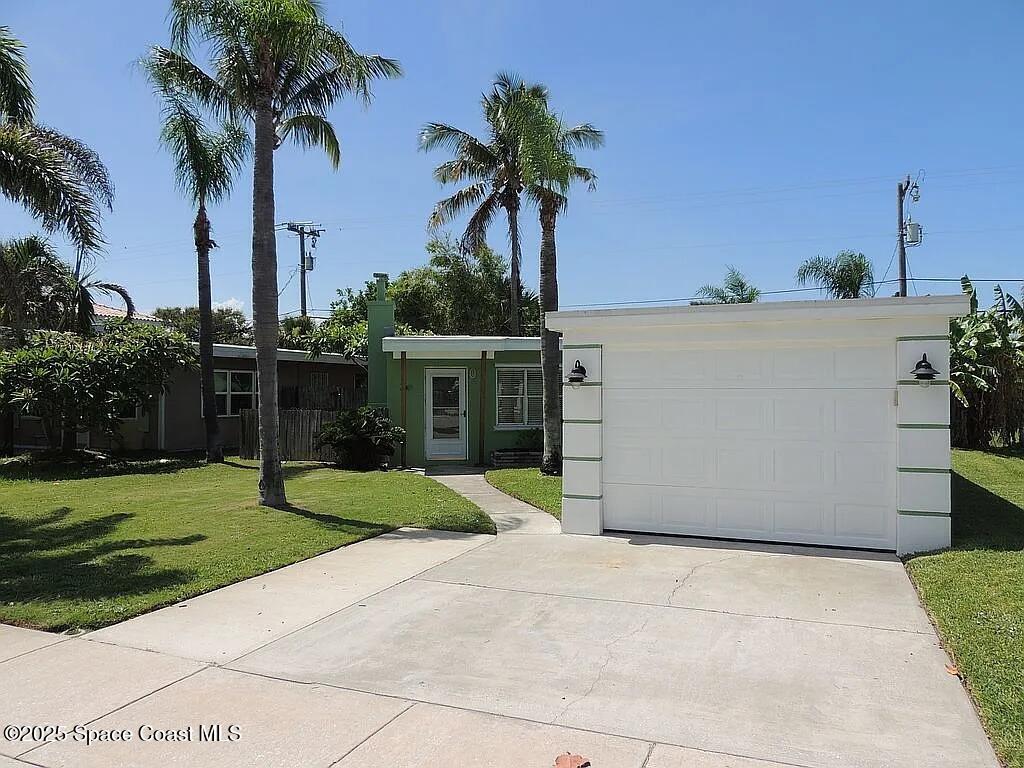 206 4th Avenue Indialantic, FL 32903 - Photo 5 of 43 a view of a house with a yard and palm trees