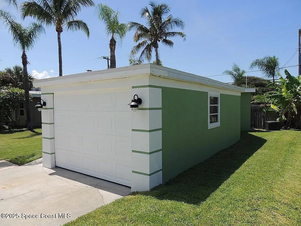 206 4th Avenue Indialantic, FL 32903 - Photo 6 of 43 a palm tree sitting in front of a house with a yard
