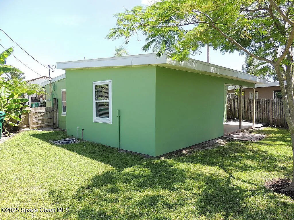 206 4th Avenue Indialantic, FL 32903 - Photo 7 of 43 a view of a yard in front of a house with large tree