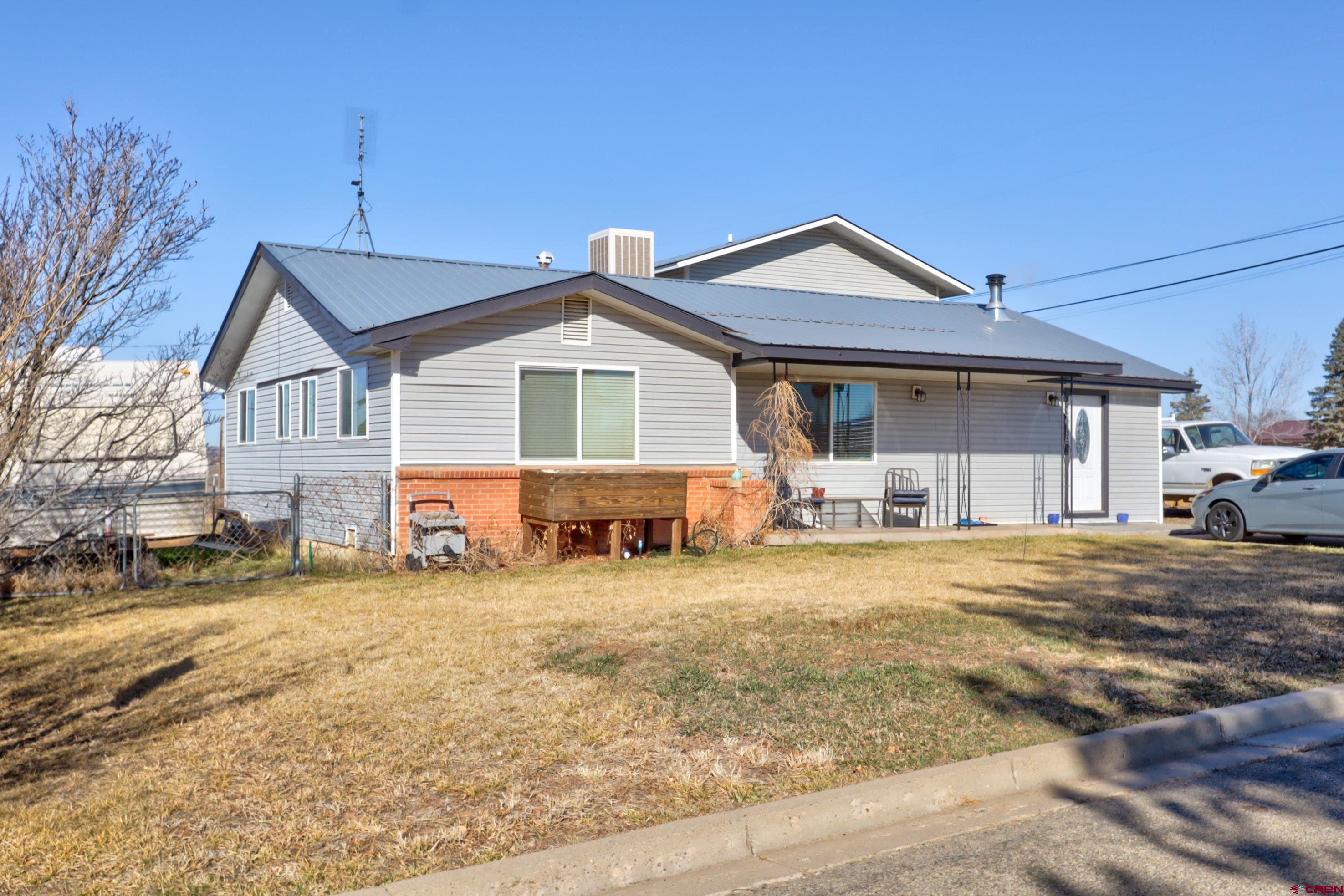 2019 Rolling Road Cortez, CO 81321 - Photo 1 of 35 a view of a house with outdoor space and a yard
