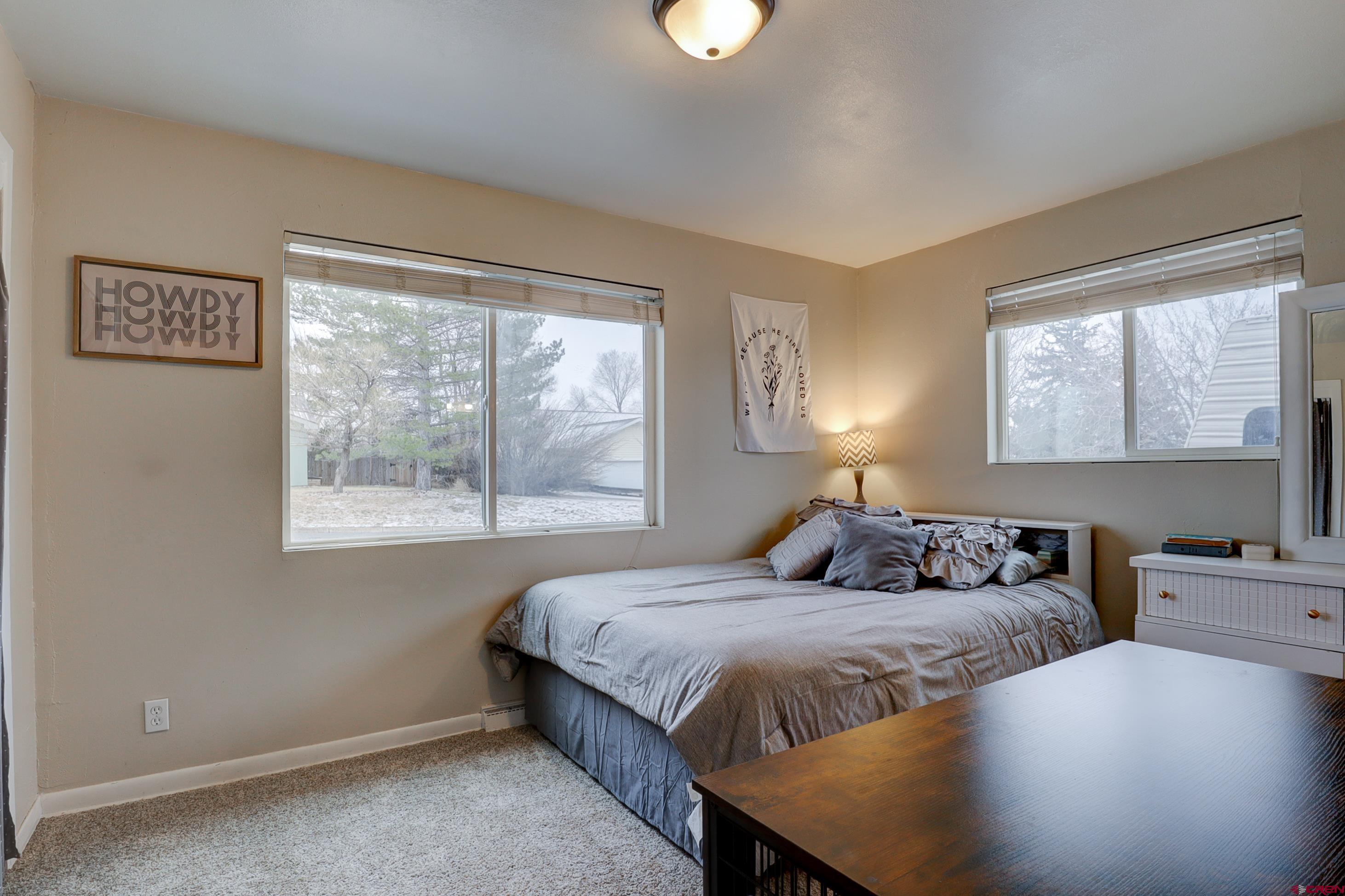 2019 Rolling Road Cortez, CO 81321 - Photo 13 of 35 a bedroom with two beds and a window