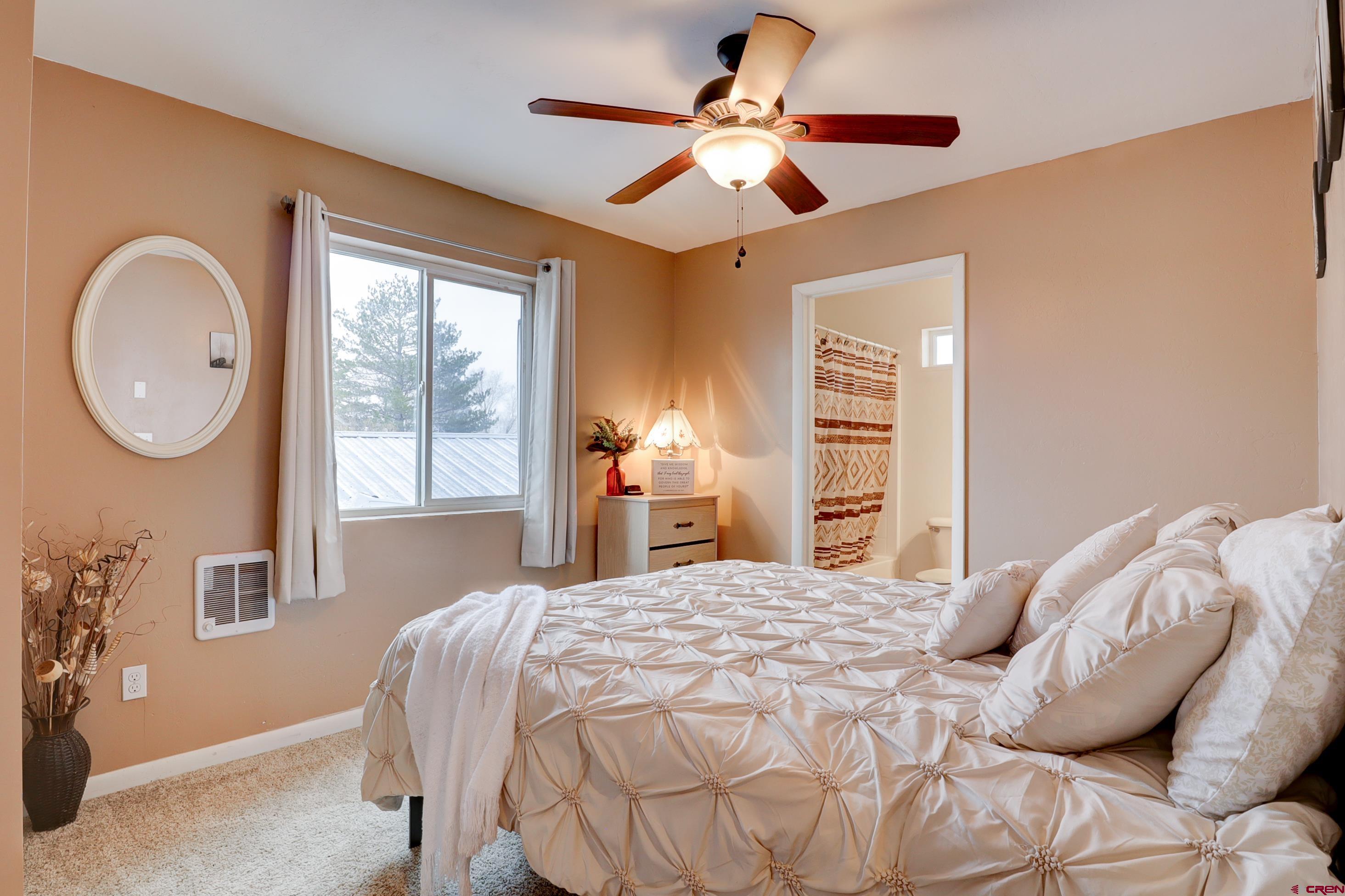 2019 Rolling Road Cortez, CO 81321 - Photo 18 of 35 a bedroom with a large bed and a chandelier