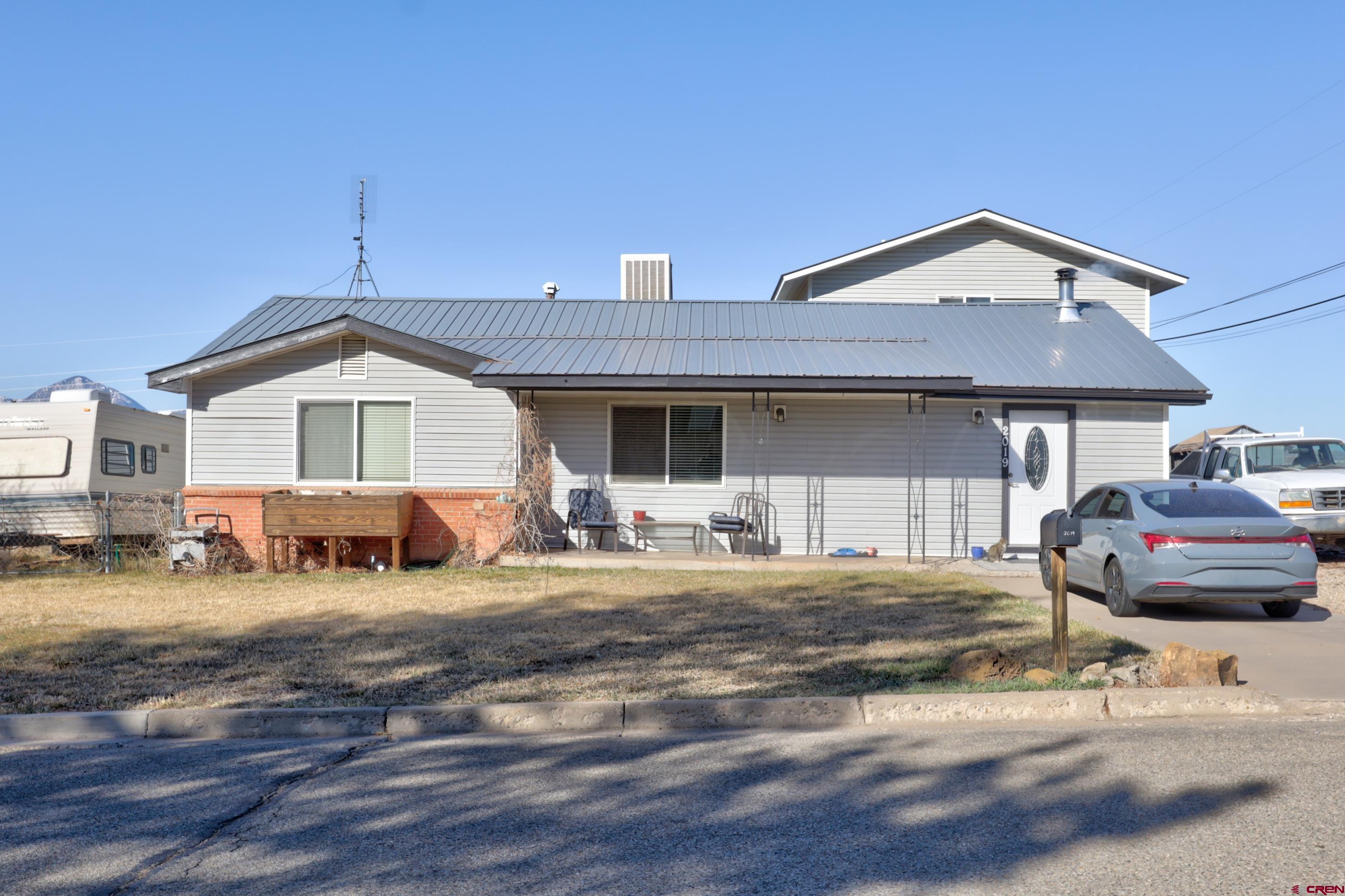 2019 Rolling Road Cortez, CO 81321 - Photo 26 of 35 a front view of a house with a garden and balcony