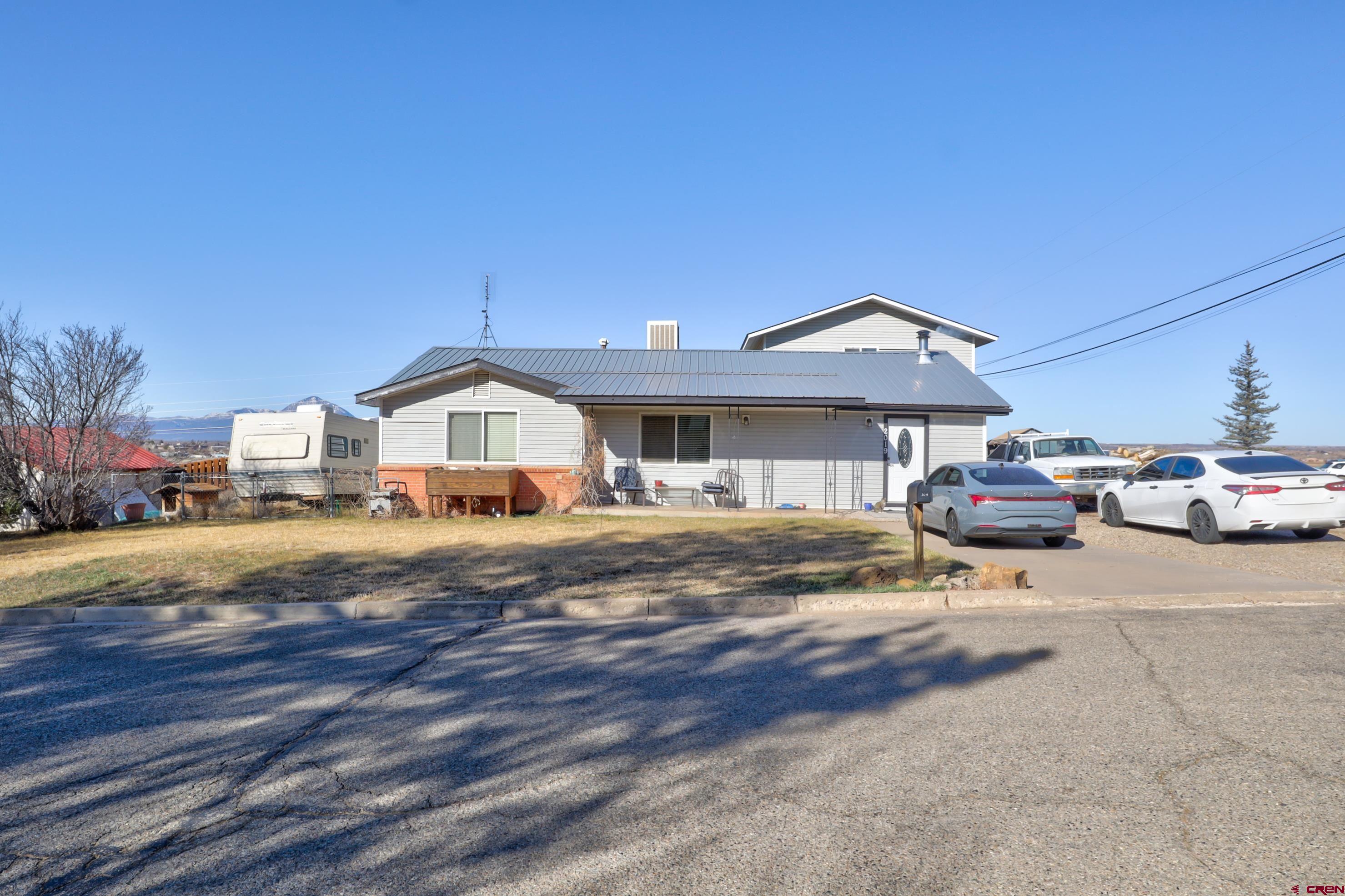 2019 Rolling Road Cortez, CO 81321 - Photo 27 of 35 a front view of a house with a garden