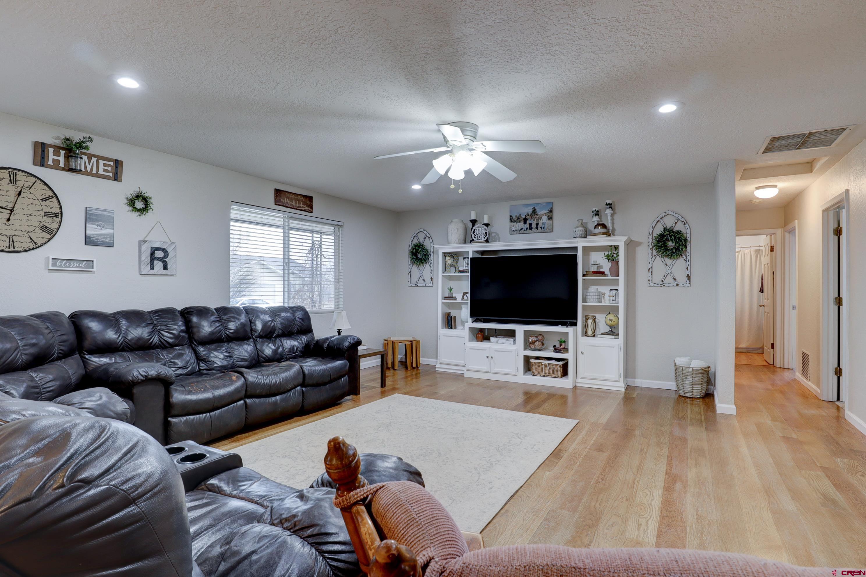 2019 Rolling Road Cortez, CO 81321 - Photo 6 of 35 a living room with furniture and a flat screen tv