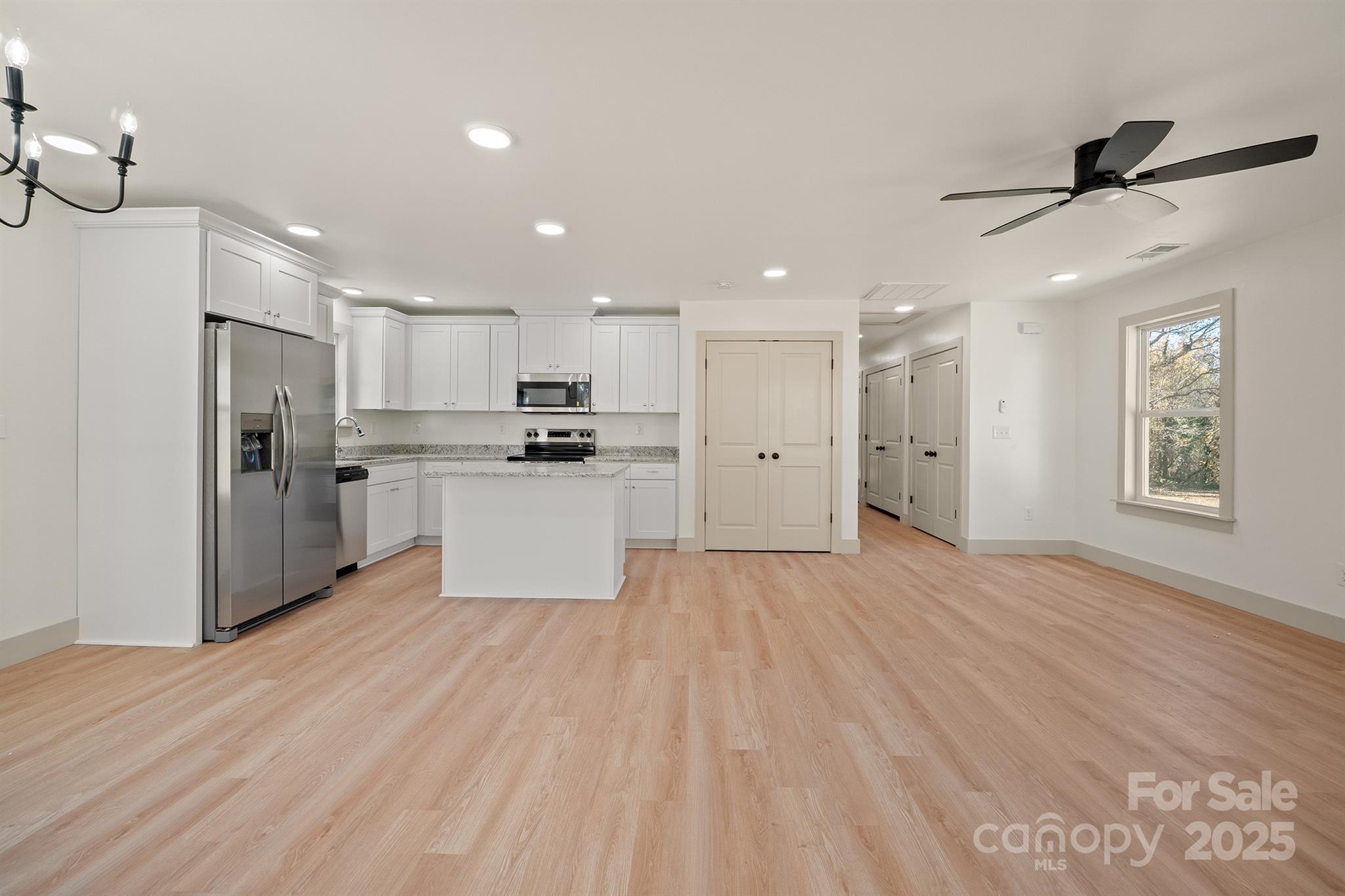 503 West 12th Street Newton, NC 28658 - Photo 12 of 38 a view of kitchen with stainless steel appliances refrigerator stove microwave and cabinets