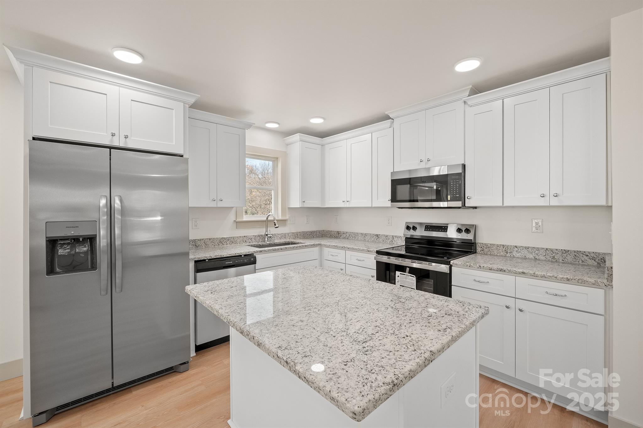 503 West 12th Street Newton, NC 28658 - Photo 16 of 38 a kitchen with granite countertop a refrigerator a sink a stove a microwave and island
