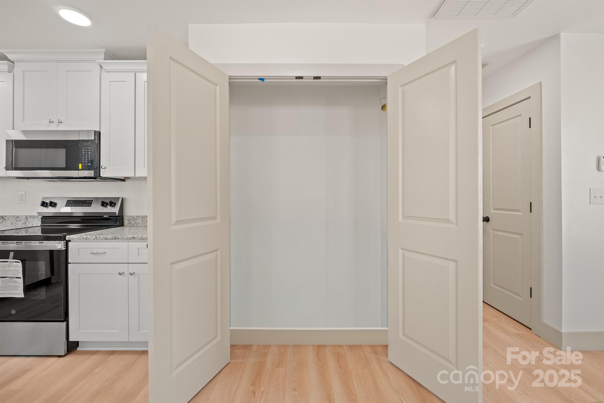 503 West 12th Street Newton, NC 28658 - Photo 20 of 38 a kitchen with cabinets and a stove top oven