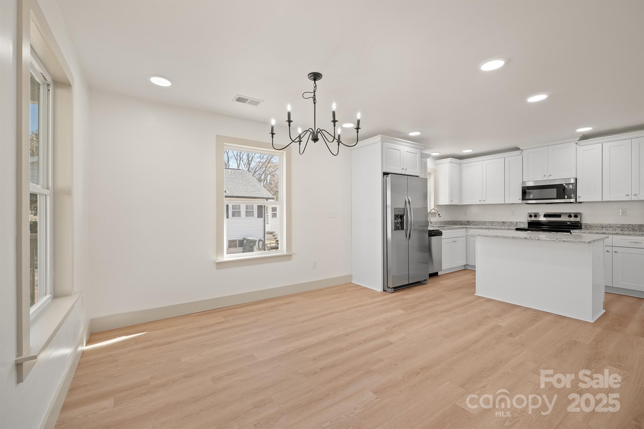 503 West 12th Street Newton, NC 28658 - Photo 8 of 38 a view of a kitchen with flat screen tv stainless steel appliances and cabinets