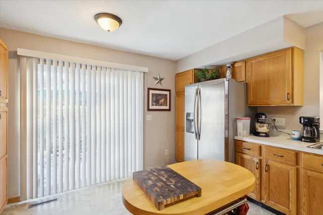 a kitchen with stainless steel appliances a refrigerator and cabinets