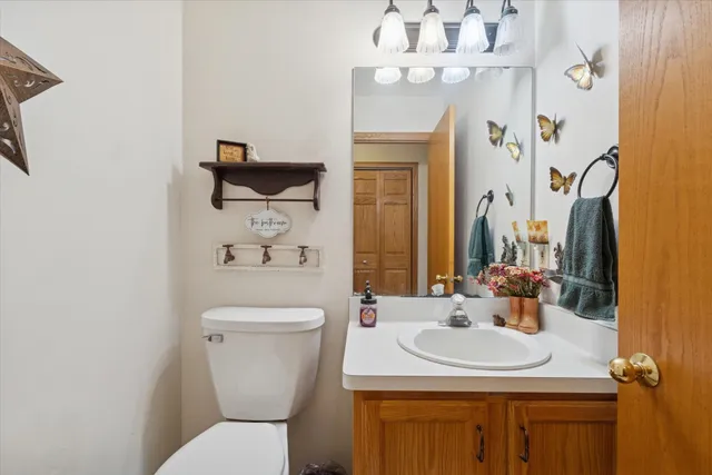 a bathroom with a sink a toilet and a mirror