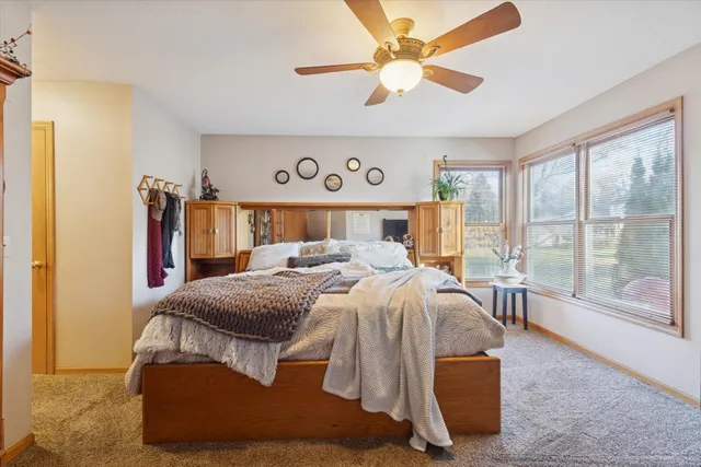 a bed room with a bed and a large window