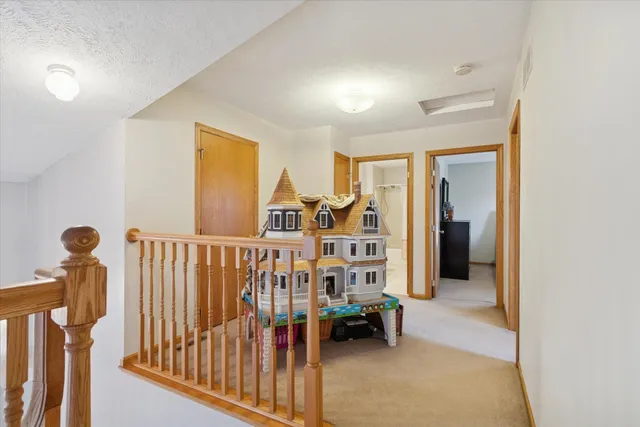 a view of a hallway with furniture and a window
