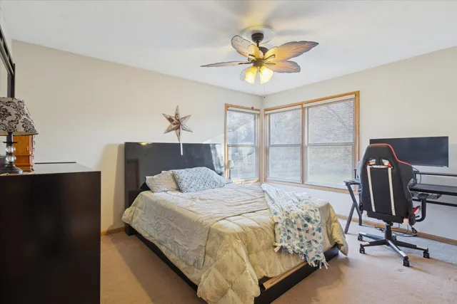 a bedroom with a bed a desk and chair