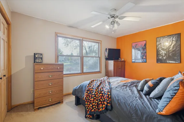 a bedroom with a bed dresser and a window