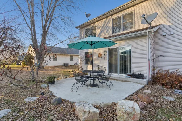 a view of a house with backyard and sitting area