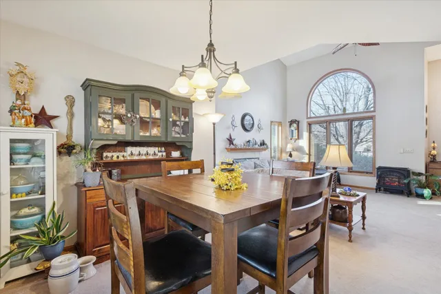 a view of a dining room with furniture and a chandelier