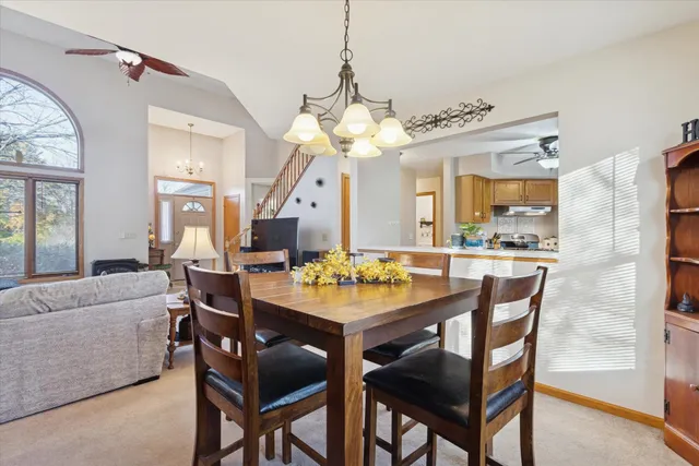 a dining room with a wooden table and chairs