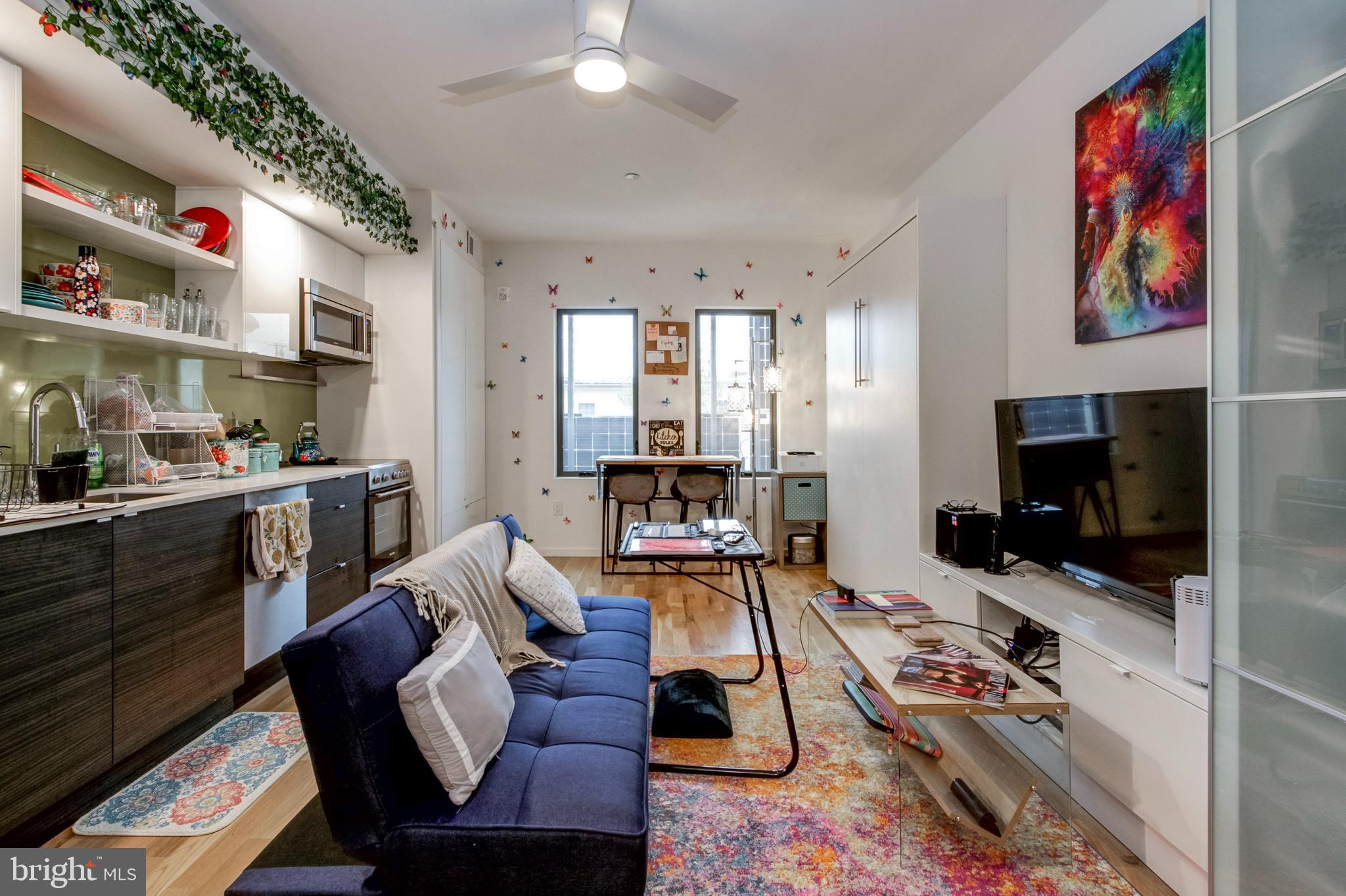 1942 North Front Street, Unit 208 Philadelphia, PA 19122 - Photo 2 of 10 a living room with furniture and a flat screen tv