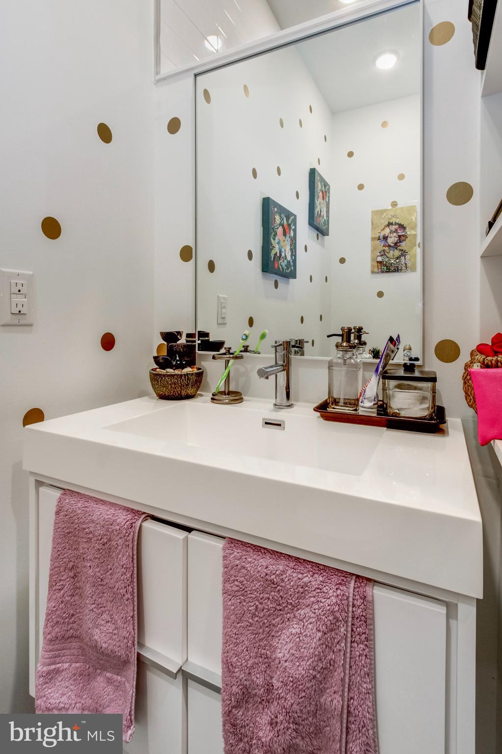 1942 North Front Street, Unit 208 Philadelphia, PA 19122 - Photo 5 of 10 a bathroom with a sink and a mirror