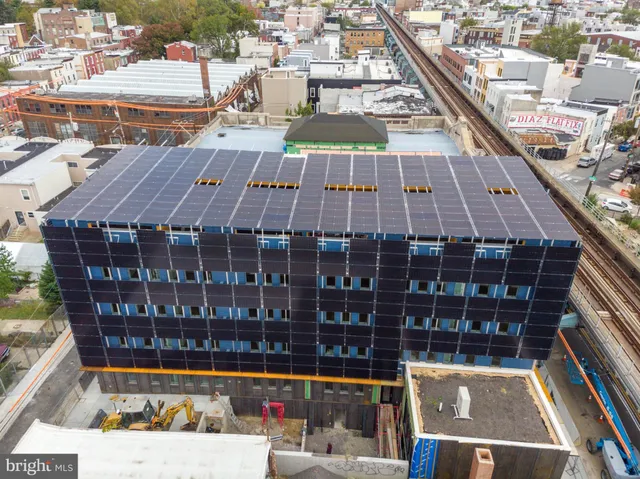 a view of a balcony with wooden floor and city view