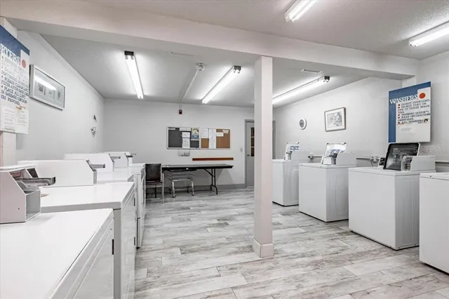 a living room with dryer and washer