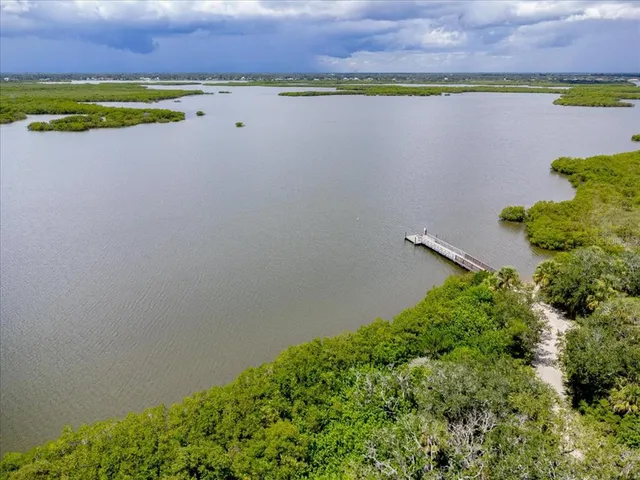 an aerial view of a houses with a lake view
