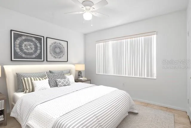 a bedroom with a large bed and a window