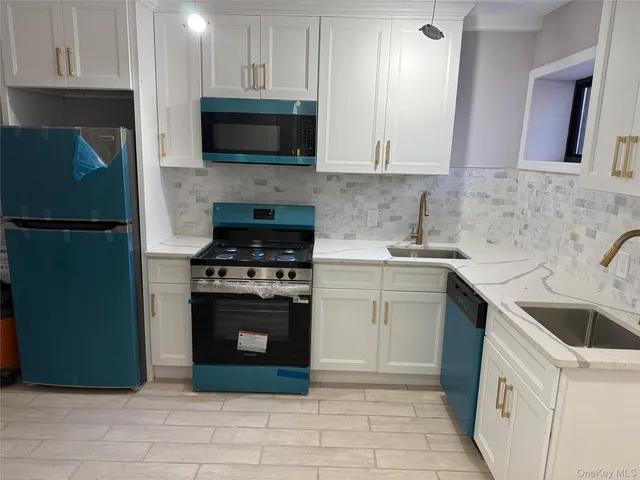 a kitchen with a sink stove and microwave