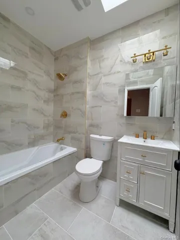 a bathroom with a toilet a sink and bathtub