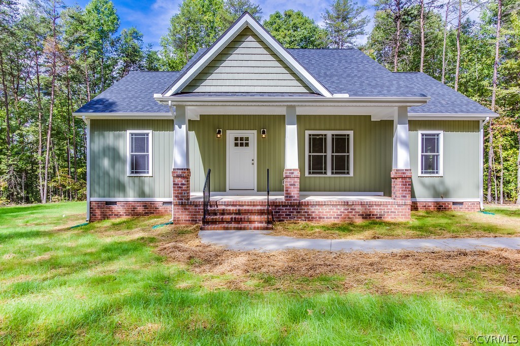 3762 County Line Road Kents Store, VA 23084 - Photo 1 of 17 a view of a house with a yard outdoor seating and covered with trees