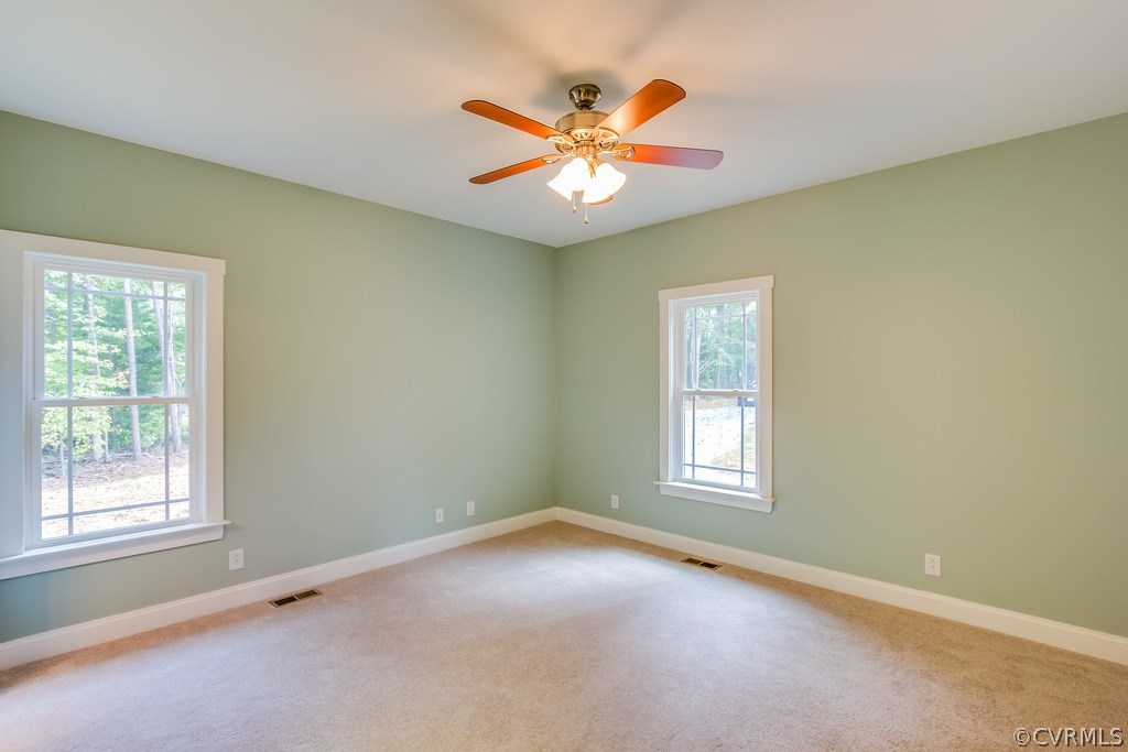3762 County Line Road Kents Store, VA 23084 - Photo 11 of 17 an empty room with window and ceiling fan