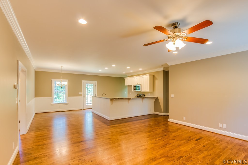 3762 County Line Road Kents Store, VA 23084 - Photo 5 of 17 a view of empty room with wooden floor and fan
