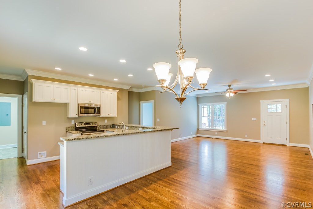 3762 County Line Road Kents Store, VA 23084 - Photo 7 of 17 a kitchen with stainless steel appliances granite countertop a sink a stove and a wooden floor