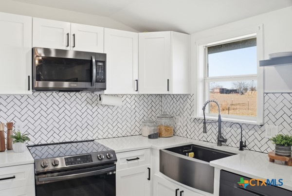 3267 Dairy Road Temple, TX 76501 - Photo 18 of 42 a kitchen with a sink and a stove top oven