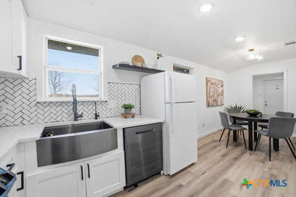 3267 Dairy Road Temple, TX 76501 - Photo 19 of 42 a kitchen with a sink cabinets and wooden floor