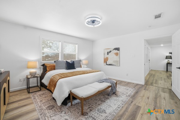 3267 Dairy Road Temple, TX 76501 - Photo 23 of 42 a bedroom with a bed and wooden floor