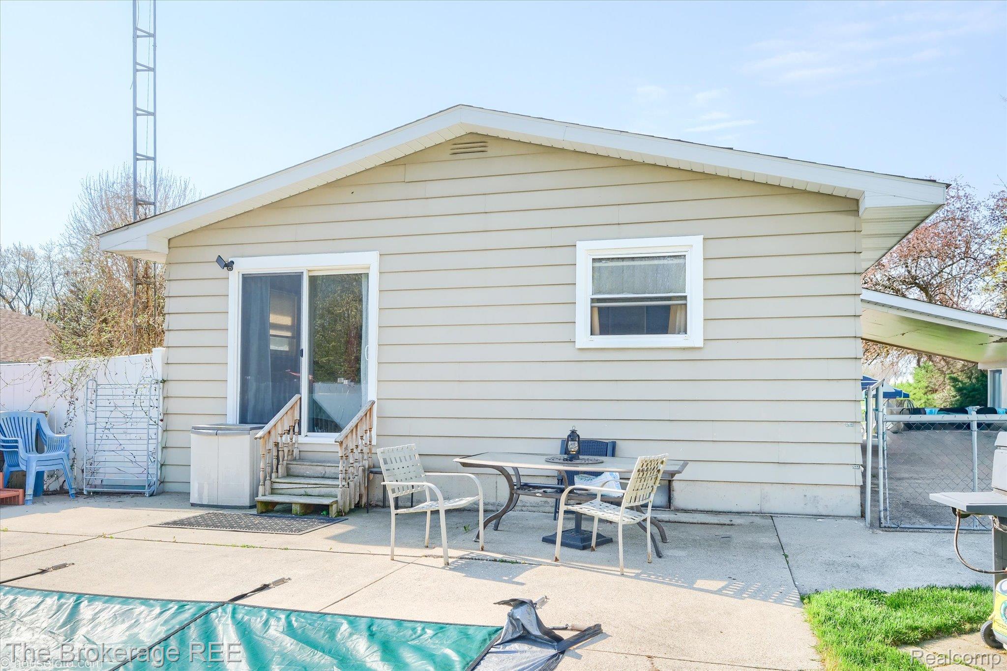 5477 Hopkins Road Flint, MI 48506 - Photo 22 of 27 Back of house featuring a patio, entry steps, and a covered pool