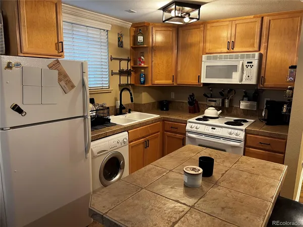 a kitchen with a stove a sink and a refrigerator