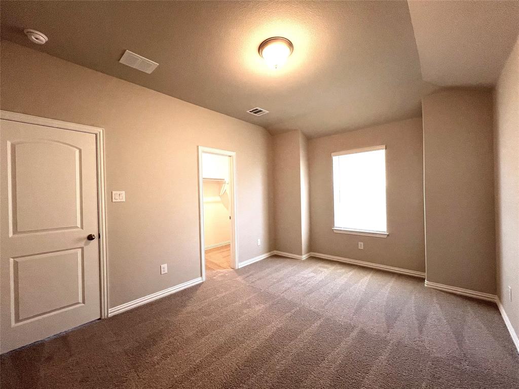 3305 Cross Shr Drive Anna, TX 75409 - Photo 28 of 31 Unfurnished bedroom featuring a walk in closet, a closet, and carpet floors