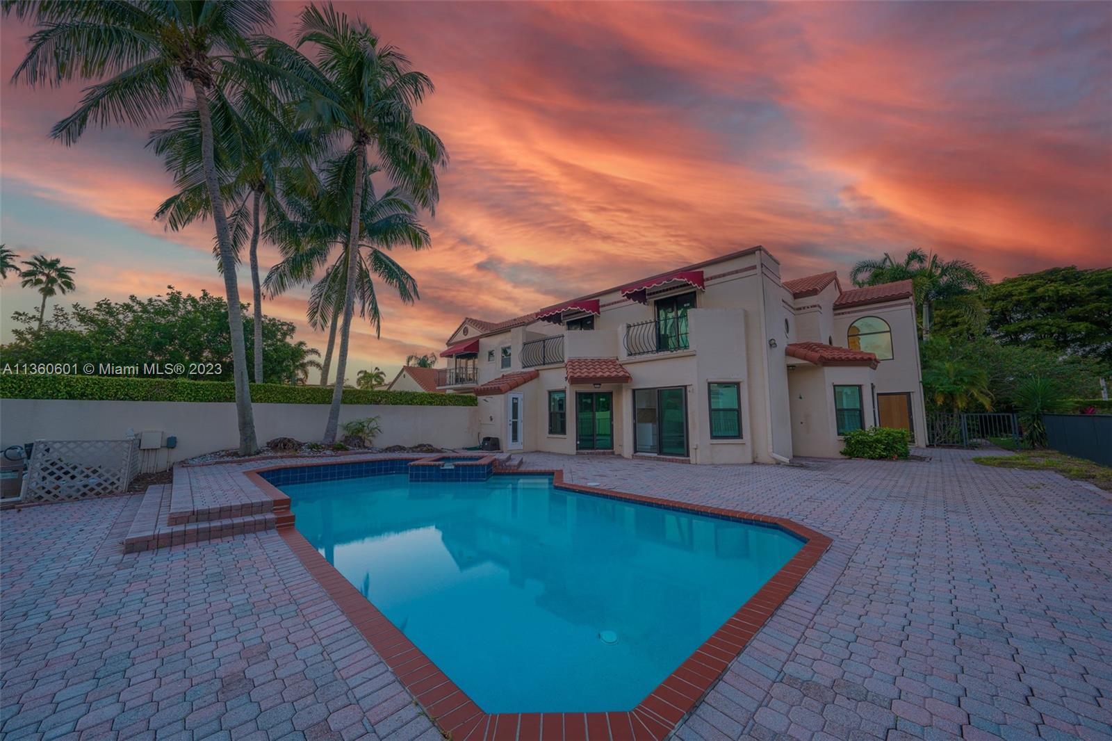 a view of a house with swimming pool and sitting area