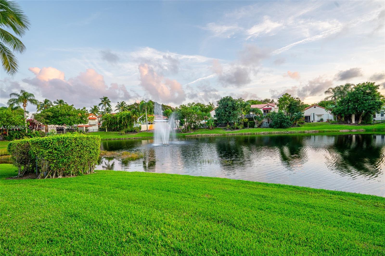 23299 Mirabella Circle North Boca Raton, FL 33433 - Photo 20 of 30 a view of a lake with a big yard and large trees