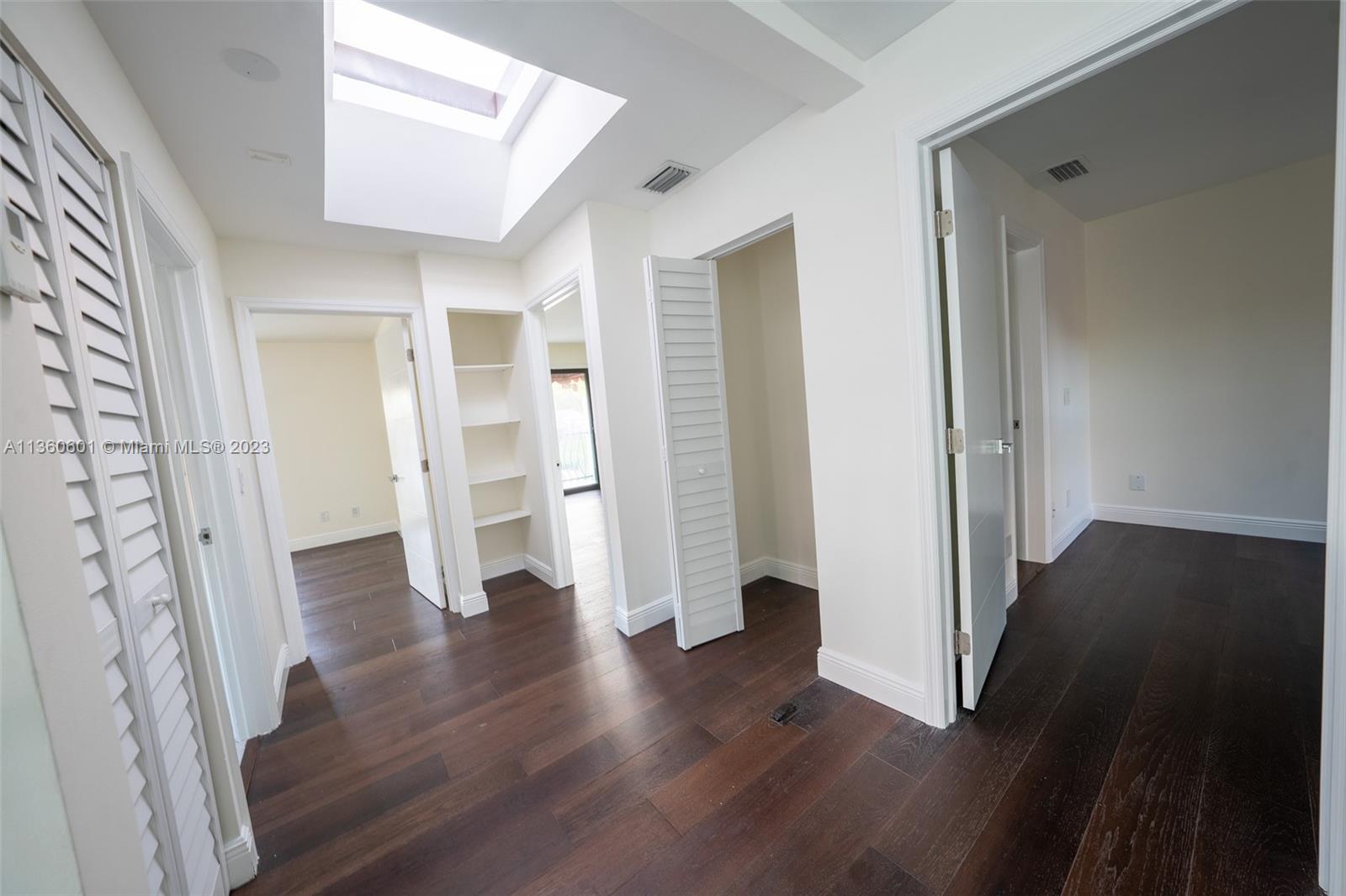 23299 Mirabella Circle North Boca Raton, FL 33433 - Photo 21 of 30 an empty room with wooden floor and entryway