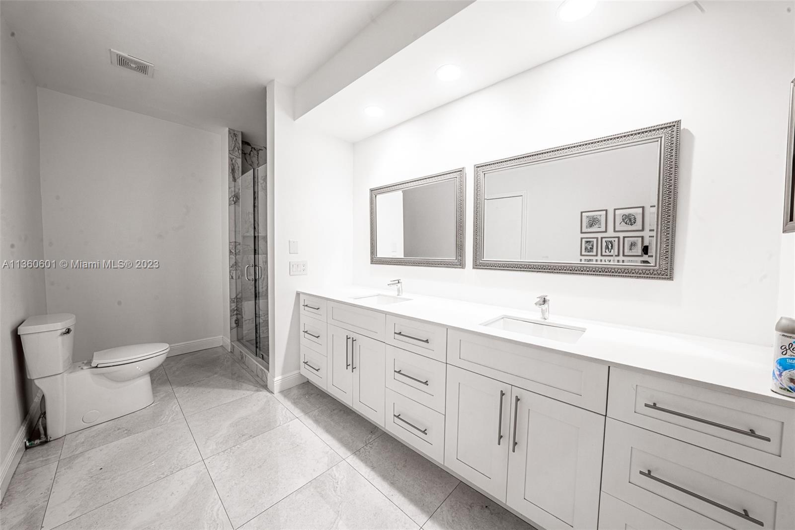 23299 Mirabella Circle North Boca Raton, FL 33433 - Photo 23 of 30 a bathroom with a toilet sink and mirror